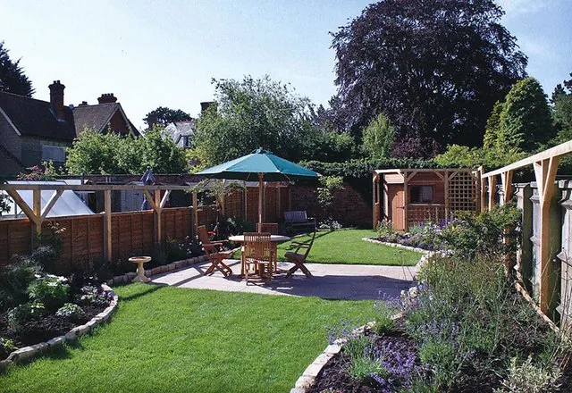 The garden with a patio, table and parasol